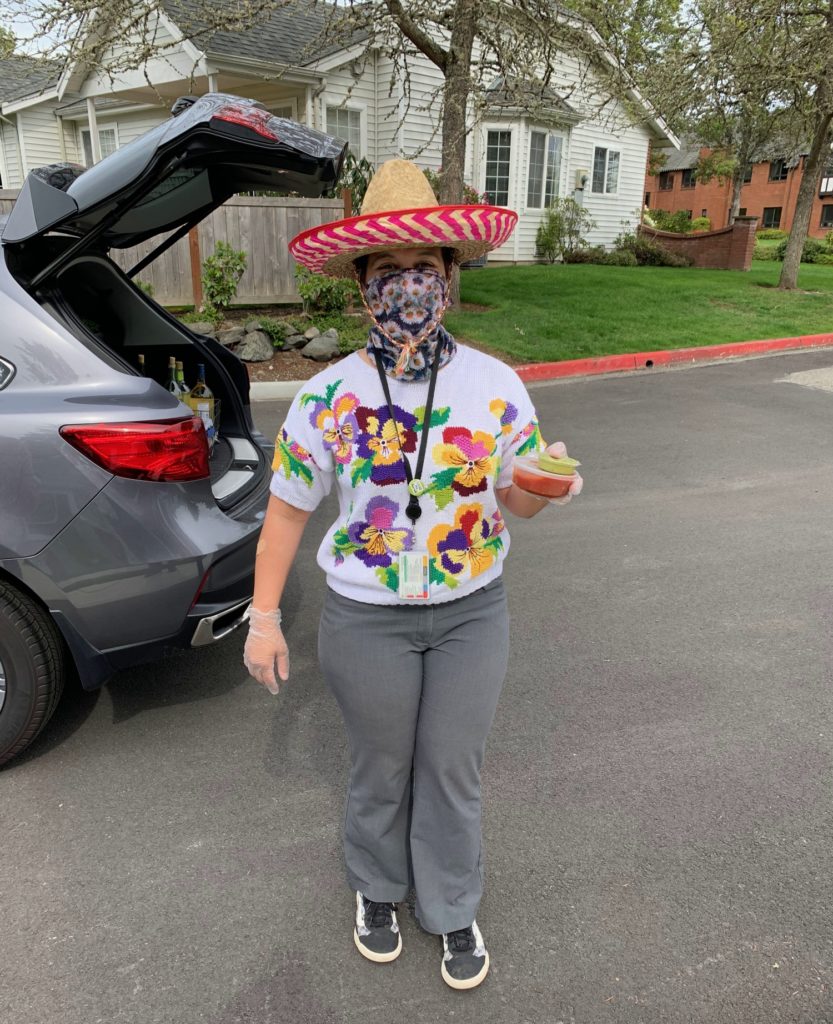 woman wearing sombrero and carrying guacamole and salsa