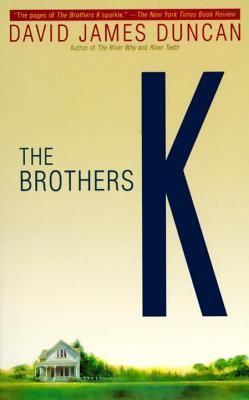 Book cover. Background: a yellow sky with a small strip of green grass and a tiny white house along the bottom edge. Text: The Brothers K [by] David James Duncan.