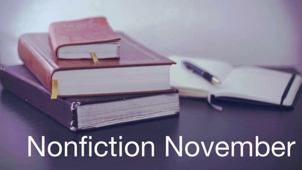 Background: 3 stacked, closed books; open notebook with pen on top. Text: Nonfiction November